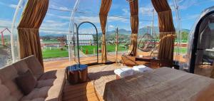 a room with a bed and a large window with a view at Maremonti Glamping in Ancarano
