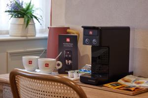 a table with two coffee cups and a microwave at The Dirty Habit in Hollingbourne
