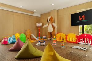 a childs play room with a stuffed animal and toys at Swiss-Belexpress Cilegon in Cilegon +27 photos