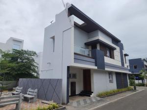 a white building with a fence in front of it at Holiday Home Madurai - Duplex Villa Umachikulam in Madurai
