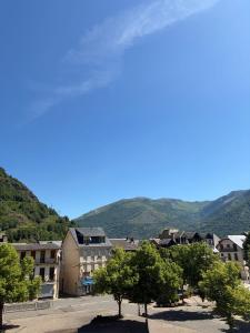 a view of a town with mountains in the background at La myrtillette in Luchon