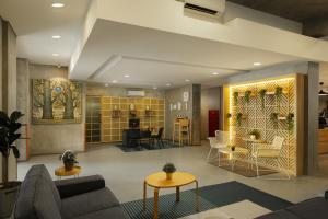 a lobby with couches and tables in a building at Swiss-Belexpress Cilegon in Cilegon