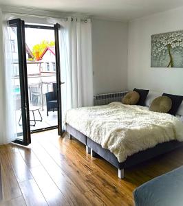 a bedroom with a bed and a large window at Ludna 3 in Niechorze