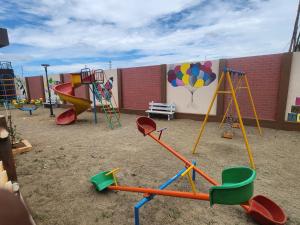 a playground with a bunch of swings and slides at Holiday Home Madurai - Duplex Villa Umachikulam in Madurai