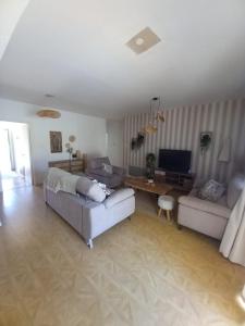 a living room with two couches and a television at Empa Residence with private pool in Emba