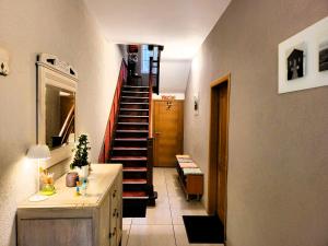 a hallway with a spiral staircase in a house at Chez Toi Ailleurs - Dinant in Dinant +15 photos