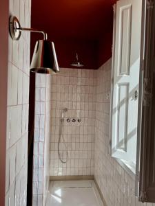 a bathroom with a shower with a light and a window at VILLA LORES Adults Only Retreat near Sanxenxo & O Grove in Lores +29 photos