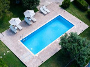 an overhead view of a swimming pool with umbrellas at Kassiani Studios Olive Groove hotel in Plakias +23 photos