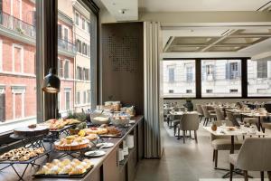 a buffet line with food on display in a restaurant at FH55 Grand Hotel Palatino in Rome
