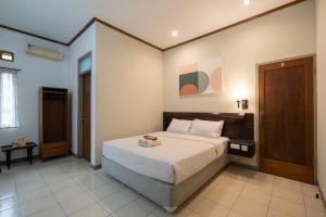 a bedroom with a bed in a room at Cove Rumah Asri in Bandung