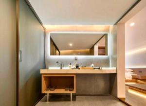 a bathroom with a sink and a mirror at 瓦述loft别院 in Zhangjiajie +217 photos