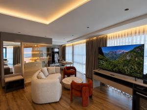a living room with a large flat screen tv at Joelle Premium Hotel in Sarandë