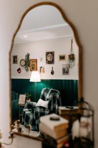 a mirror reflection of a living room with a couch at Magiczny Salonik Harrego - Magical Old Town Apartment in Toruń +66 photos