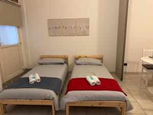 two beds sitting next to each other in a room at In Bottega Apt 1 in Bosisio Parini