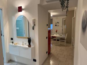 a bathroom with a sink and a mirror and a table at In Bottega Apt 1 in Bosisio Parini +35 photos
