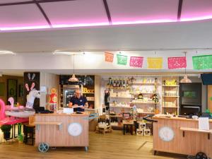 a store with a man standing in the middle of a room at Hôtel Mercure Lille Aéroport in Lesquin