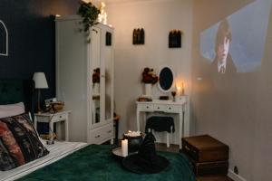 a bedroom with a bed with a candle and a fireplace at Magiczny Salonik Harrego - Magical Old Town Apartment in Toruń