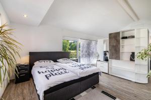 a bedroom with a large bed with white walls at Ferienwohnung Jeannette in Balingen