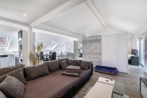 a living room with a couch and a dining room at Ferienwohnung Jeannette in Balingen