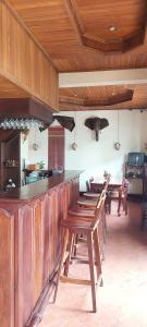 a kitchen with wooden counters and wooden tables and chairs at Villa Saykham in Luang Prabang