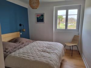 a bedroom with a bed and a window and a chair at Maison Arios in Came
