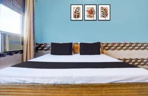 a bedroom with a large bed in a room at Samrat Hotel in Sambhal
