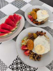 three plates of food on top of a table at MJR Ticketing Guest House in Ruteng
