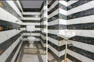 a bathroom with a toilet and a sink at Samrat Hotel in Sambhal