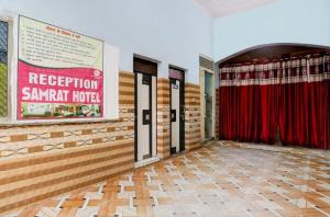a room with red curtains and a sign on the wall at Samrat Hotel in Sambhal
