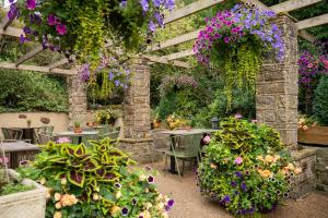 a garden with tables and chairs and flowers at Scotsman's Pack Hotel in Hathersage