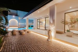 a living room with a table and chairs at Salt & Palm Villa in Maggona West