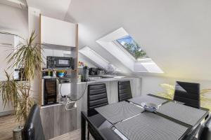a kitchen and dining room with a table and a window at Ferienwohnung Jeannette in Balingen