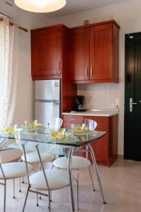 a kitchen with a table and chairs with food on it at Corfu Glyfada Beach Apartment 86 in Glyfada