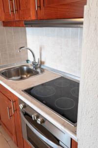 a kitchen with a sink and a stove top oven at Corfu Glyfada Beach Apartment 86 in Glyfada +38 photos