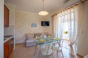 a kitchen and living room with a table and chairs at Corfu Glyfada Beach Apartment 86 in Glyfada