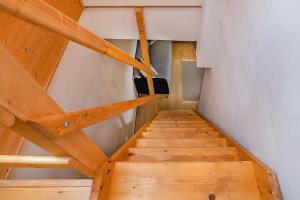 a staircase in a house with wooden ceilings at Apartmán Maštal in Osek +20 photos
