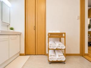 a towel rack with towels on it in a kitchen at K2Guesthouse Konohana in Osaka +25 photos