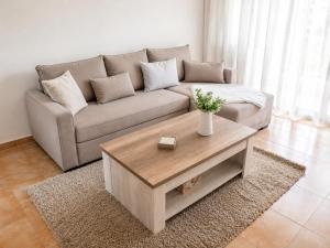 a living room with a couch and a coffee table at Primavera Pool Paradise in Arona