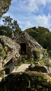 a stone house with a bench in front of it at Rifugio Ortobene in Nuoro