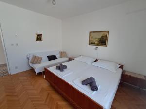 a living room with two beds and a couch at Tucepi Kamena 57 in Tučepi