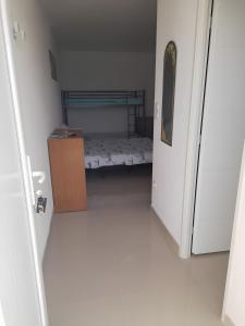 a small room with a bunk bed and a door at Césaria in Loupian