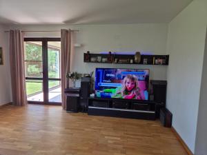 a flat screen tv sitting in a living room at Paradisul de la țara in Moara Vlăsiei