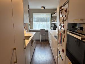 a kitchen with white cabinets and a window at Rofabær 45 in Reykjavík +1 photo