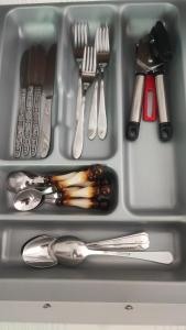 a tray filled with utensils and spoons and forks at Hartikkalan Apartments in Lappeenranta