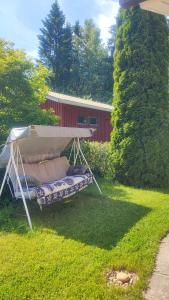a gazebo in the grass in a yard at Hartikkalan Apartments in Lappeenranta