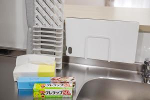 a kitchen counter with a sink and a microwave at Anecis名楽町 in Nagoya +39 photos