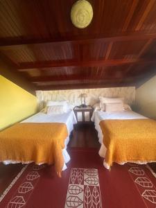 a room with two beds in a room at Casa abuelo Ramón in Narón