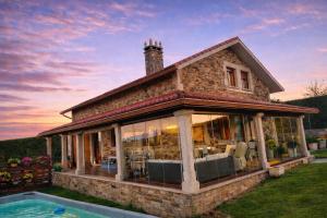 a house with a pool in front of it at Casa abuelo Ramón in Narón +31 photos