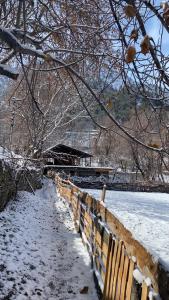 a fence covered in snow next to a field at Kalash Echo Lodge in Chitral +31 photos
