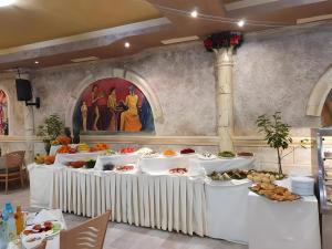 a buffet table with food on it in a church at Balneo & SPA Hotel Aura in Velingrad
